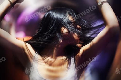 Preview: Dancing the night away. A young woman dancing.