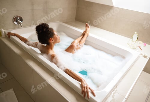Preview: A young woman is happily bathing in a bathtub