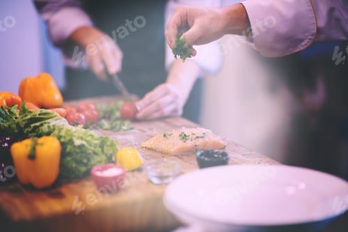 Preview: Chef hands preparing marinated Salmon fish