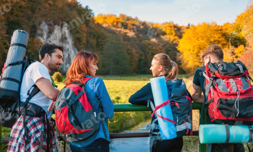 Preview: Group of friends during a tourist trip with backpacks