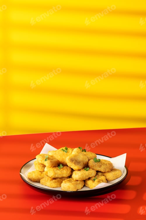 Preview: Delicious golden chicken nuggets on a plate on the table. Fast food, menu.