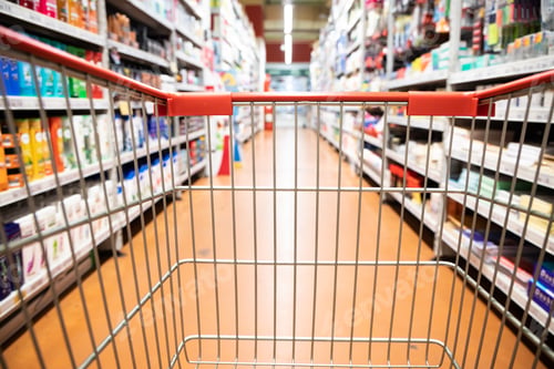 Preview: Perspective view shopping trolley cart with supermarket aisle blurred background