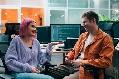 Preview: young programmers working on a new project for a start up business.