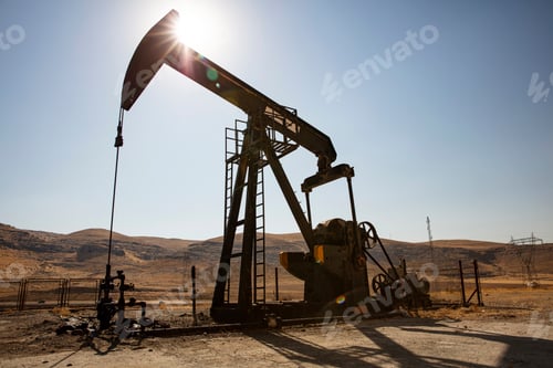 Preview: Oil drilling derricks at desert oilfield.