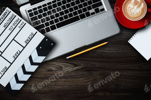 Preview: office stuff with Movie clapper, laptop, smartphone, tablet, coffee cup, pen, notepad and documents