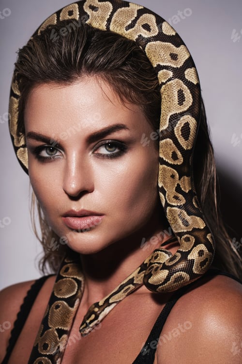 Preview: Beautiful woman with a python snake gracefully positioned on her head like a crown