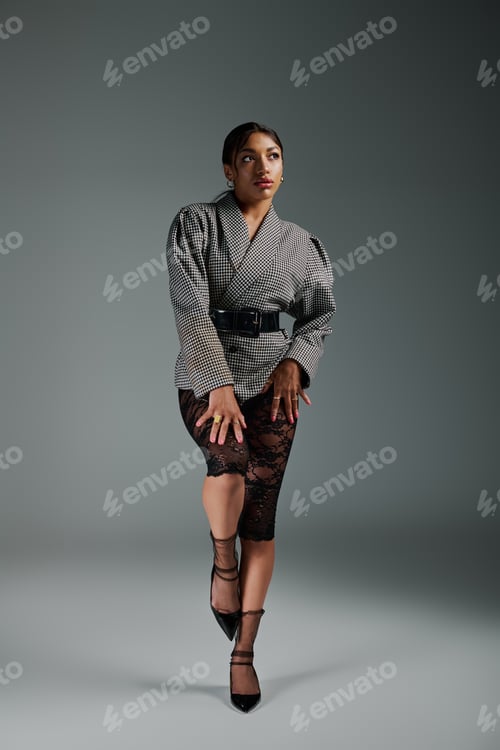 Preview: Chic expressions of a young woman in stylish fashion standing in a modern studio