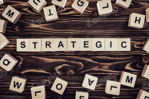 Preview: top view of strategy inscription made of wooden blocks on brown wooden surface