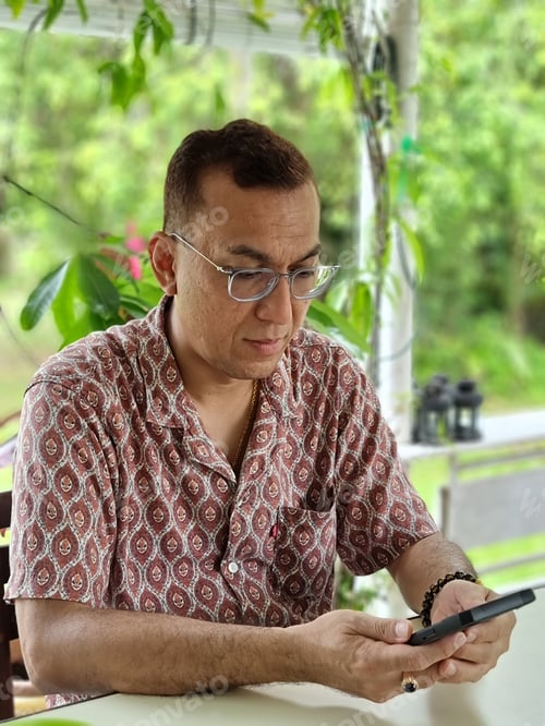 Preview: Portrait of an Asian man using mobile phone