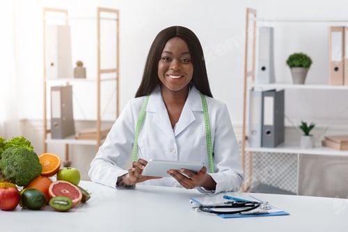 Successful dietologist smiling at her modern office
