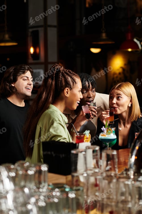 Preview: Young diverse colleagues enjoying drinks and laughter at a corporate party celebration