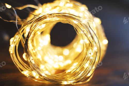 Preview: christmas beautifull shiny gold garland on a wooden brown background. sparkle festive background
