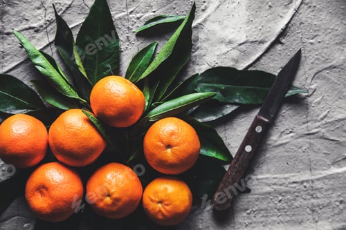 Preview: Citrus on table: mandarin, tangerine with a knife. Fresh organic juicy fruits