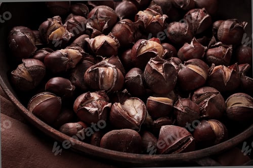 Preview: Roasted chestnuts, in an iron pan, wooden table, top view, no people, rustic style,