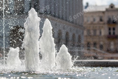 Preview: Close up of high mighty gush of cold clean sparkling transparent fresh water of a fountain. White