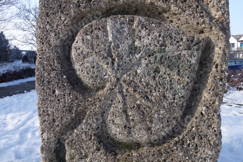 Preview: Closeup shot of a stone with a leaf figure curved on it