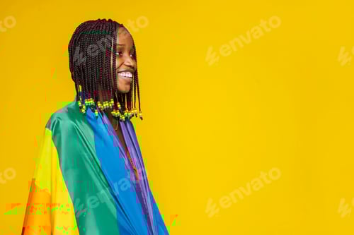 Preview: African smiling woman with rainbow flag over yellow background