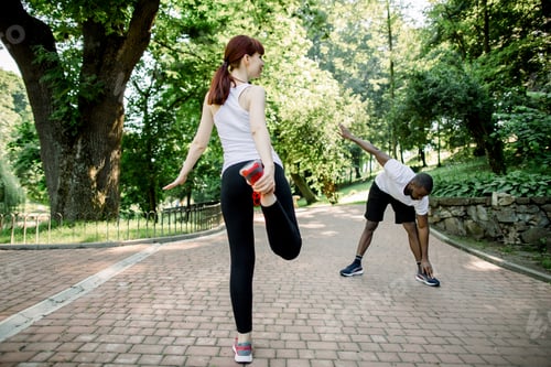 Preview: Caucasian red haired girl and African guy, warming up and stretching before morning running