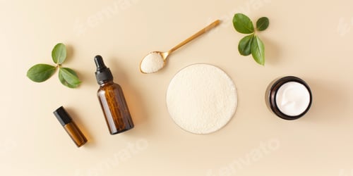 Preview: Anti-aging cosmetics and collagen powder in a petri dish on a beige background
