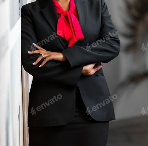 Preview: Professional Woman in Suit with Arms Crossed Posing