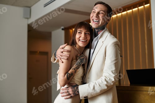 Preview: Young couple shares a joyful moment in a hotel setting during their romantic getaway