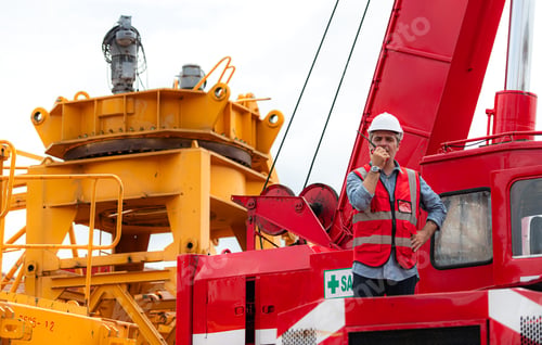 Preview: Crane foreman uses walkie-talkie and inspect the construction crane lifting heavy items