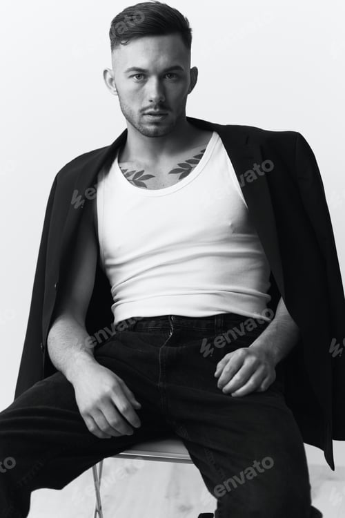 Preview: Modelling snapshots. Serious self-confident attractive handsome man in black jacket sitting on chair