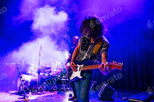 Preview: Rock and roll group performing live.