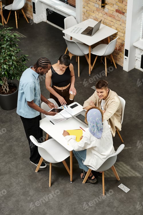 Preview: coworking, happy african man gesturing near colleagues, business people discussing startup project
