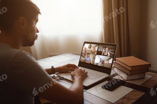 Preview: Man Working From Home Having Online Group Videoconference On Laptop