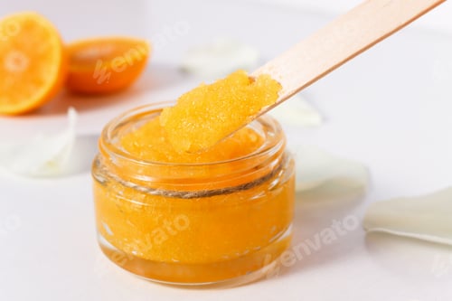 Preview: Sugar body scrub with ripe, juicy oranges on a white wooden table.