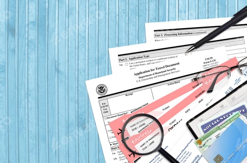 Preview: USCIS form I-131 Application for travel document lies on flat lay office table and ready to fill