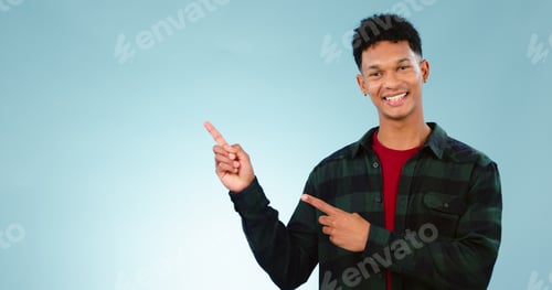 Preview: Portrait, smile and man with hand pointing to studio for mockup, space or news on blue background.