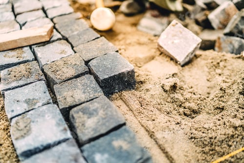 Preview: Close up details of roadworks. Stonework on footpath at construction site