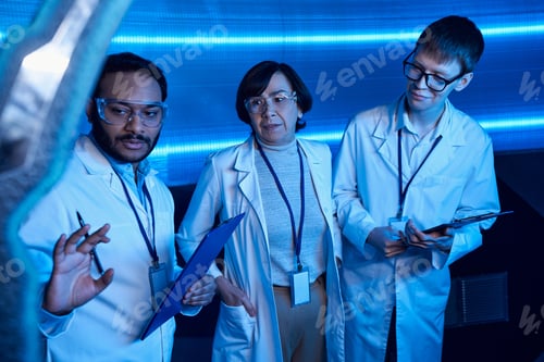 Preview: exploring future, indian scientist showing innovation to colleagues in discovery center