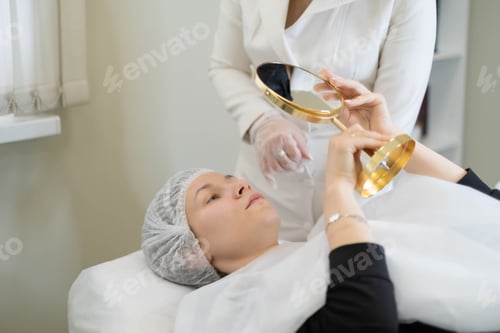 Preview: Client examines her skin post-treatment, the reflection of satisfaction. A personalized skincare