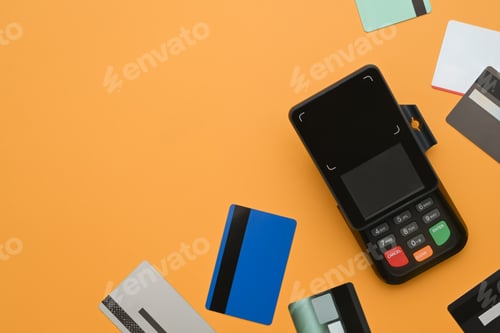 Preview: Modern bank payment terminal and credit cards on yellow background. Modern payment systems concept