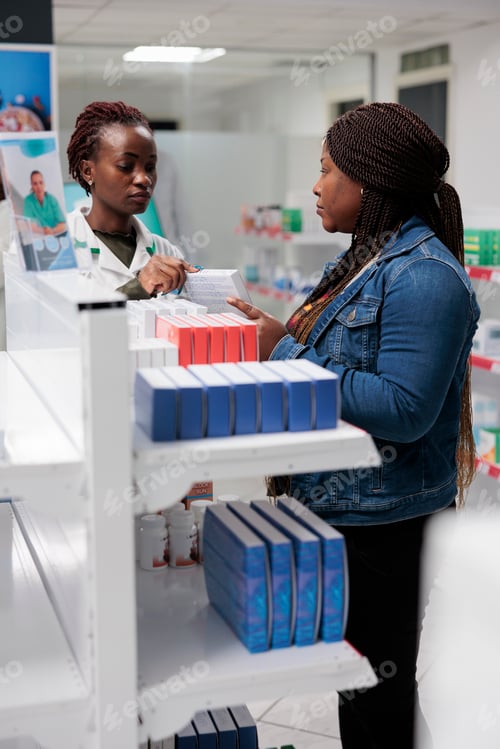Preview: African american pharmacy assistant explaining buyer vitamins instruction