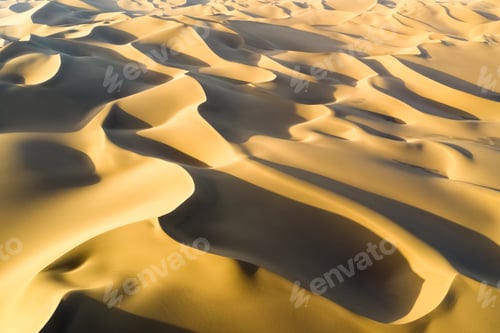Preview: aerial view of desert landscape in sunset, golden sand dunes background texture