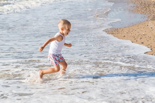 Preview: Boy Runs Joyfully on the Beach in Summer