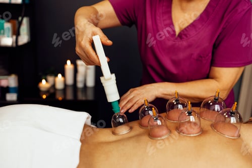 Preview: Faceless masseur rubbing back of customer