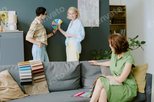 Preview: Middle Aged Caucasian Women Discussing Color Swatches in Modern Living Room