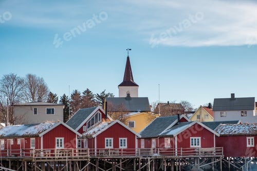 Preview: Christian church on red fishing village at coastline