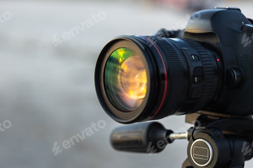 Preview: Close up of camera lens with sunlight reflection. Lens at golden hour.