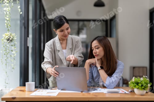 Preview: Business adviser using a laptop to analysis graph company financial budget report and cost work