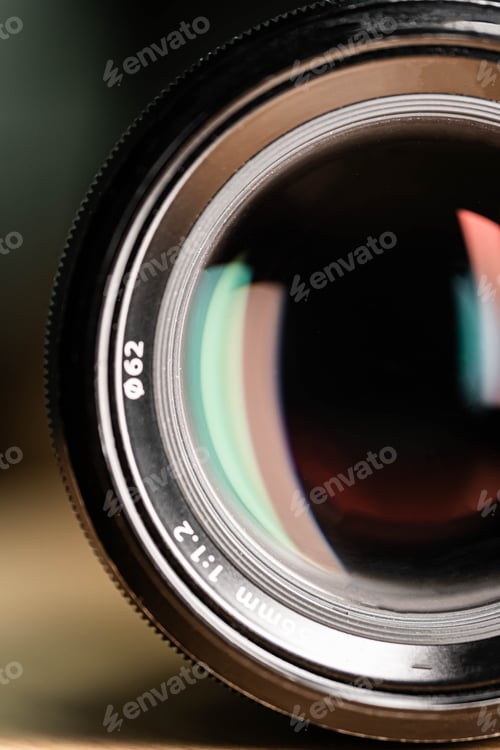 Preview: High-resolution close-up of a professional 56mm f/1.2 camera lens on a wooden surface.