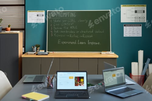Preview: Classroom Showing Laptops on Table and Chalkboard Displaying AI Prompting Steps