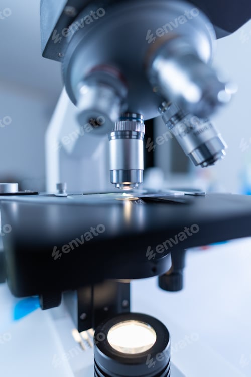 Preview: Close-up shot of microscope with metal lens at laboratory.