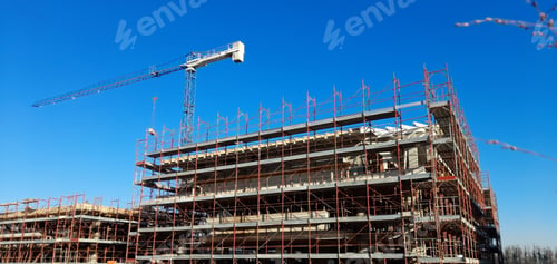 Preview: Crane tower and scaffolding on buildings at the construction site