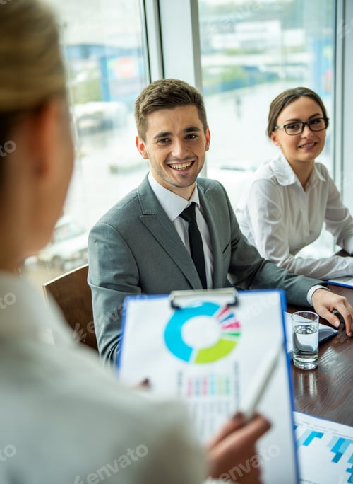 Preview: Business meeting with chart discussion.